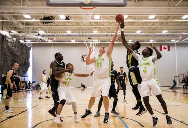 Algonquin College Thunder 38-year-old rookie Dan Stoddard goes up for a rebound against the Centennial Colts during their OCAA basketball game in Toronto, on Nov. 4.