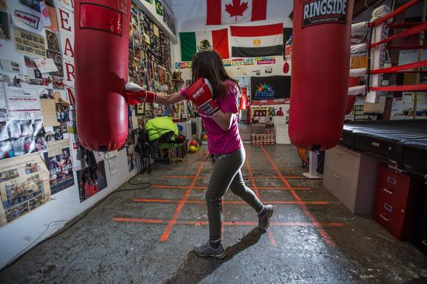 Mychaelynn Tenn, a member of the MJKO youth boxing charity, works out in the club's warehouse space.