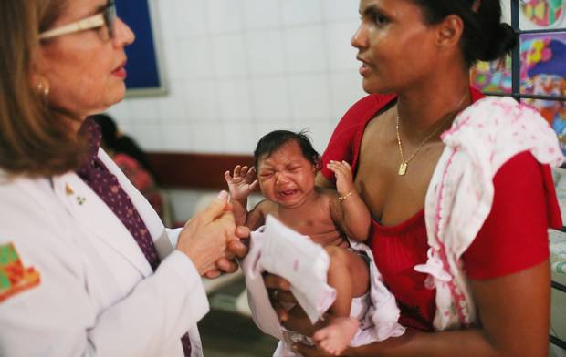 A pediatric infectologist at Oswaldo Cruz Hospital in Recife, Brazil speaks to Ivalda Caetano, grandmother of two-month-old Ludmilla, who has microcephaly.